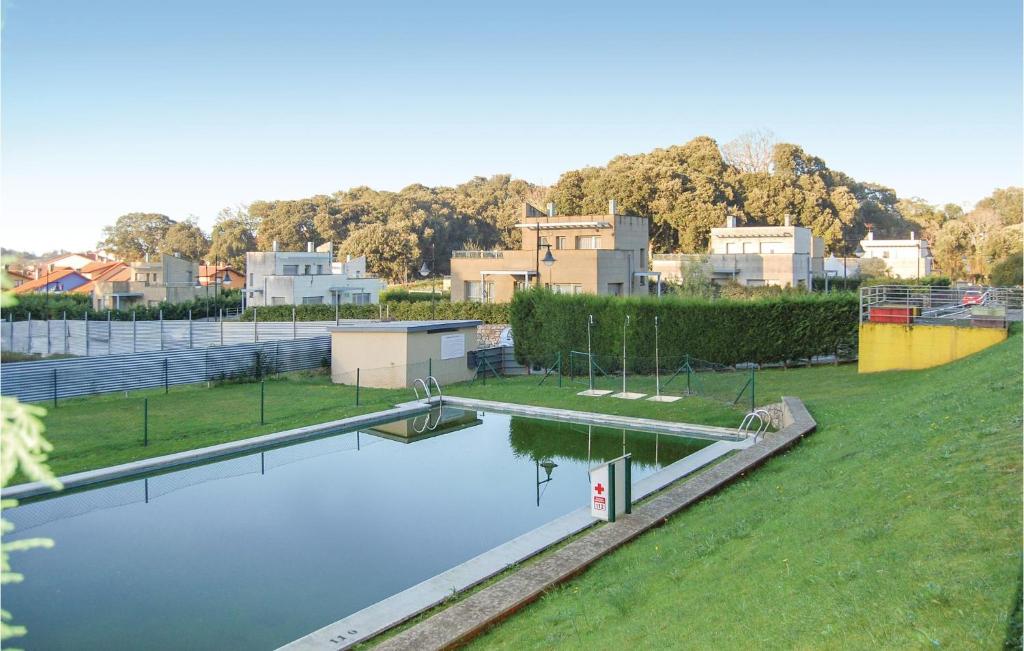 una gran piscina de agua en un parque con casas en Beautiful Apartment In Llanes With Kitchen en Llanes