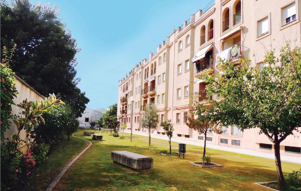 a large building with a park in front of it at 3 Bedroom Nice Apartment In Jerez De La Frontera in Jerez de la Frontera