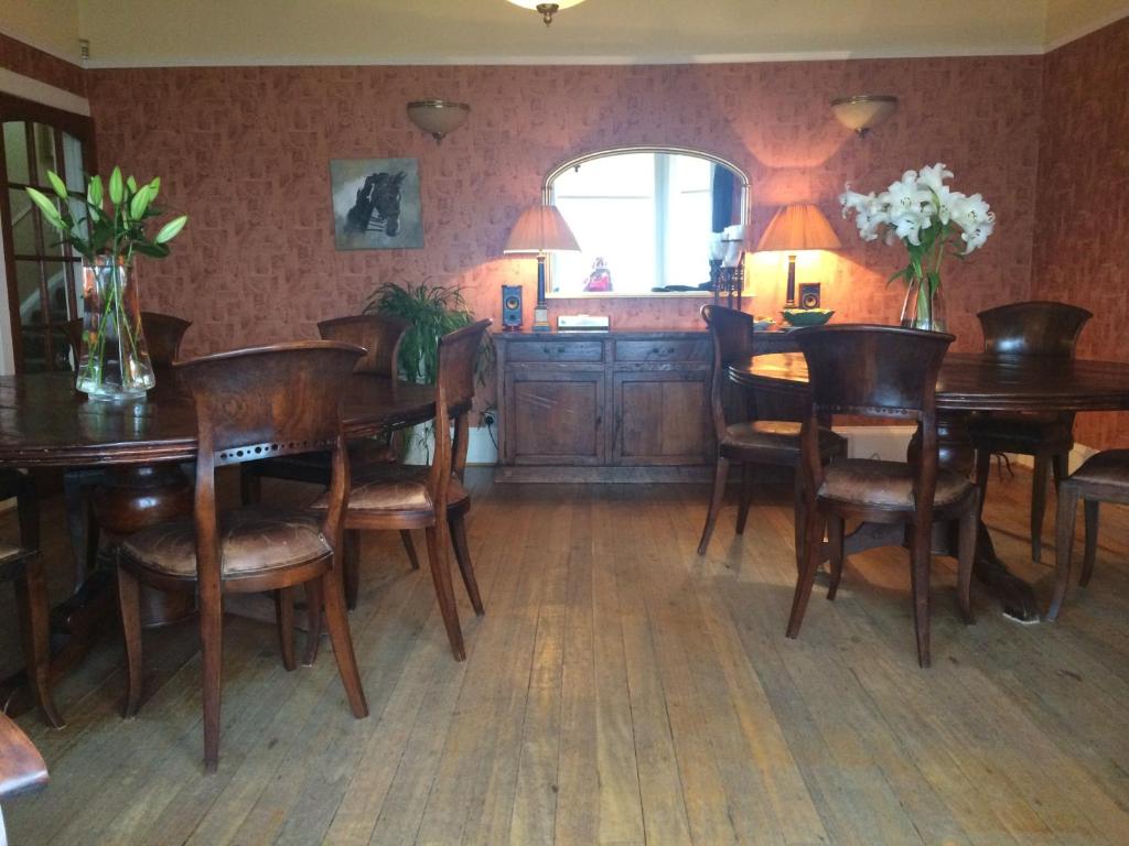 a dining room with wooden tables and chairs at Broom Lodge in Largs