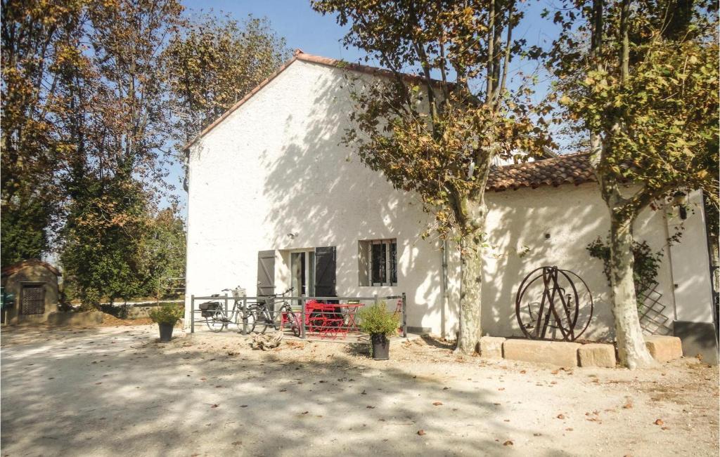 a white house with a table and chairs in front of it at Amazing Home In Narbonne With Sauna in Narbonne