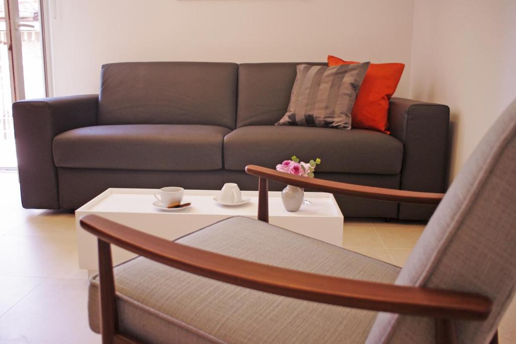 a living room with a couch and a coffee table at Guest House Villa Dagmar in Crikvenica