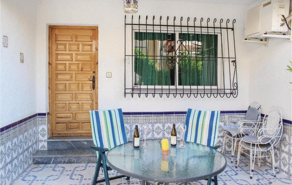 ロス・アルカサレスにあるBeautiful Home In Los Alcazares With 2 Bedroomsのパティオ(テーブル、椅子、ドア付)