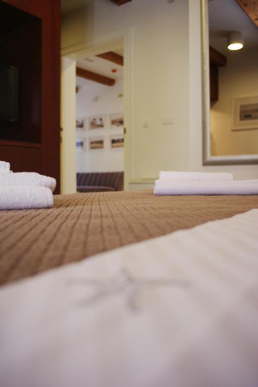 a close up of a bed with a mirror at Guest House Villa Dagmar in Crikvenica