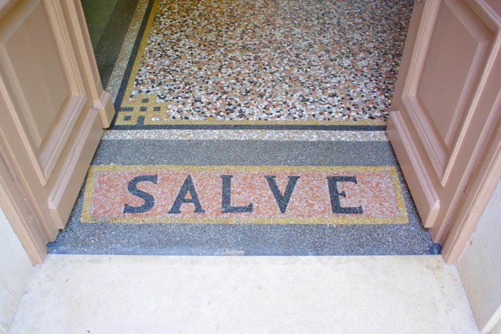 a door with the word saliva written on the floor at Guest House Villa Dagmar in Crikvenica