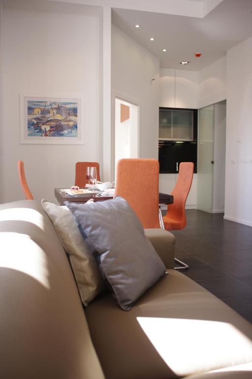 a living room with a couch and a table at Guest House Villa Dagmar in Crikvenica