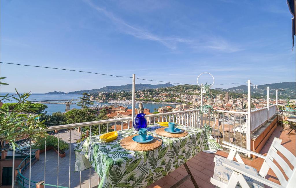 a balcony with a table and chairs and a view of the city at Casa Zigoela in Rapallo