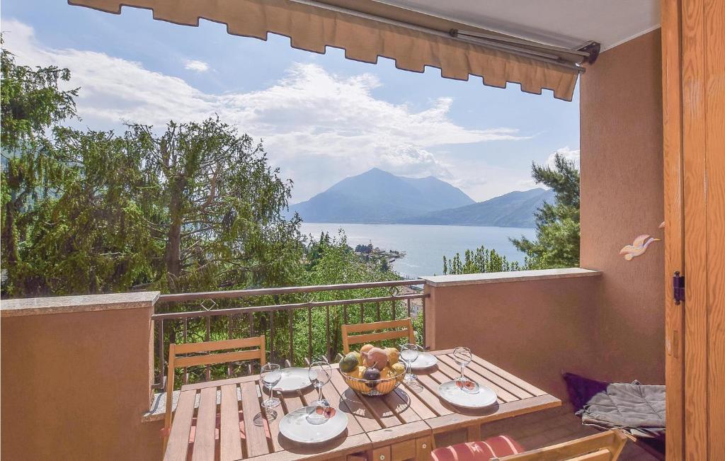 a table on a balcony with a view of the water at Casa Giovanna in Bellano