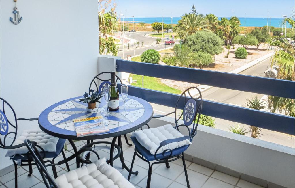 a balcony with a table and chairs and a view of the ocean at 2 Bedroom Beautiful Apartment In Orihuela Costa in Orihuela Costa