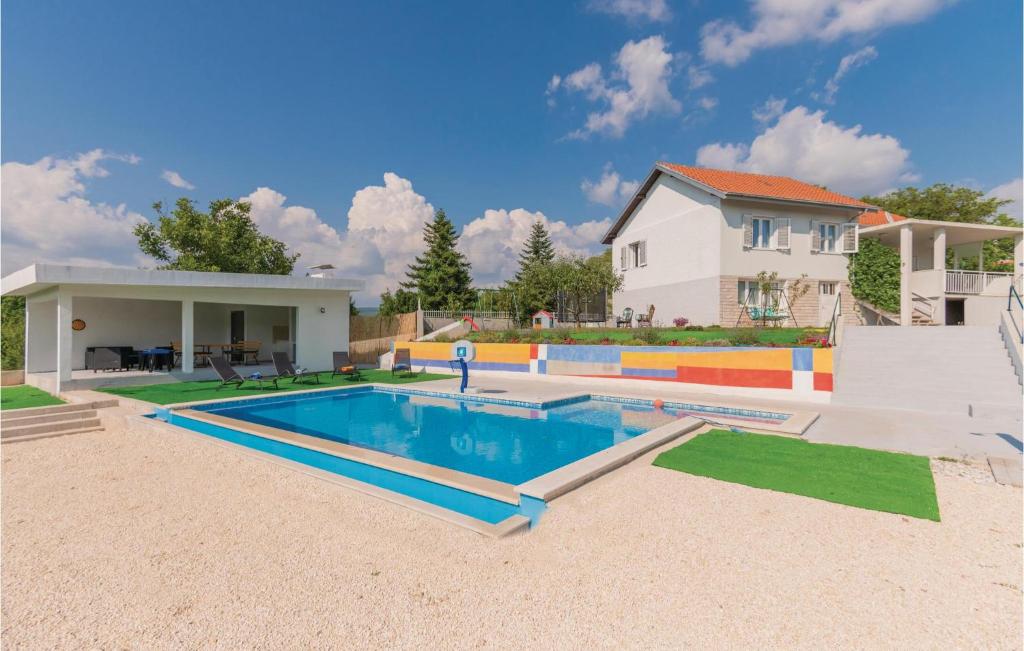 a swimming pool in the backyard of a house at 3 Bedroom Gorgeous Home In Vinjani Gornji in Aračići