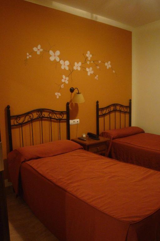 Łóżko lub łóżka w pokoju w obiekcie Hotel Las Rosas