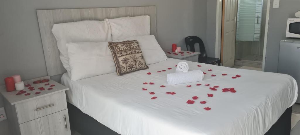 a bedroom with a bed with red roses on it at Zea 85 BnB in Vereeniging