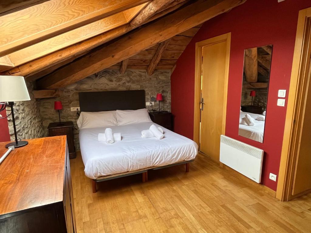a bedroom with a bed with two towels on it at Casa de poble acollidora,amb llar de foc, in Bourg-Madame