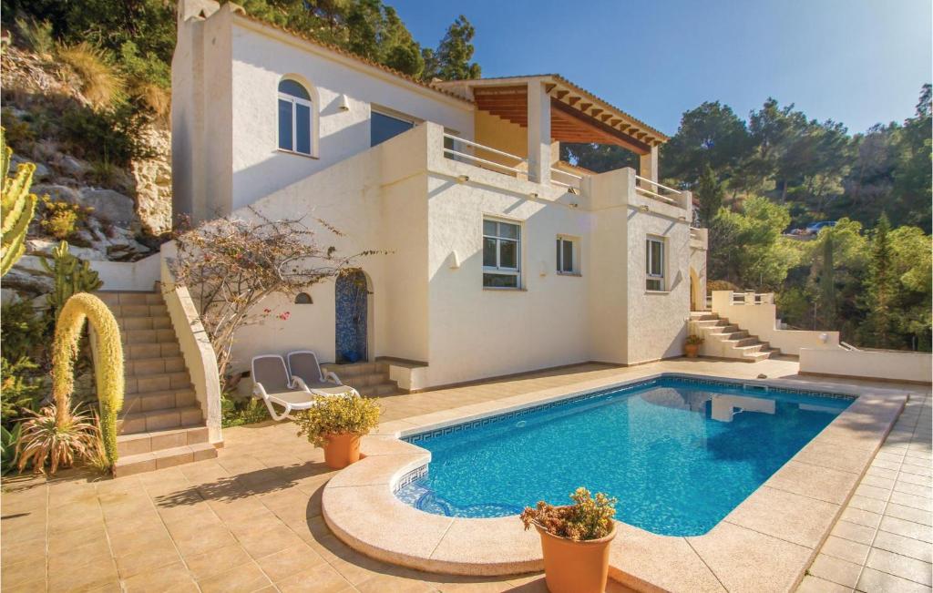 a villa with a swimming pool in front of a house at Urb,urlisa 1 in Altea la Vieja