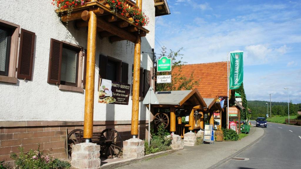a building with flowers on the side of a street at Landhotel Engel in Limbach
