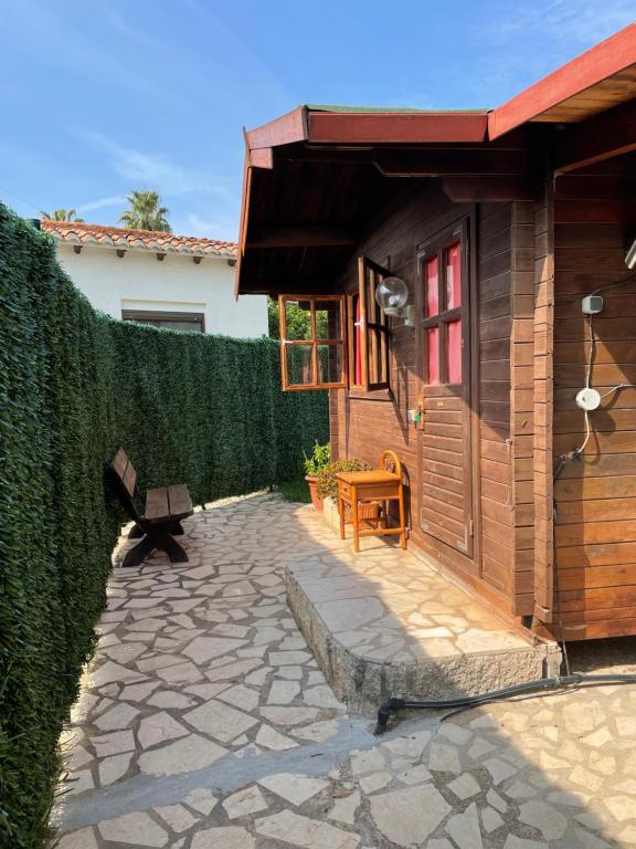 a patio with a building with a fence and a bench at La casita de invitados in Denia