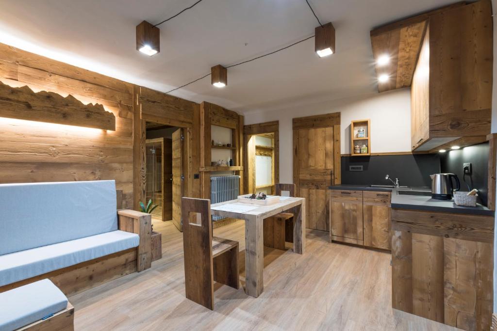 a kitchen with wooden walls and wooden flooring at Casaborgovecchio Abete Rosso-Sauna in Bardonecchia