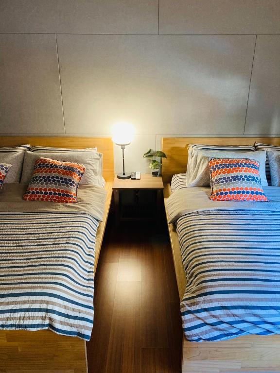 Postel nebo postele na pokoji v ubytování Sinnan12 Homestay桃園市民宿059號
