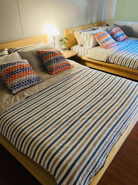 Postel nebo postele na pokoji v ubytování Sinnan12 Homestay桃園市民宿059號