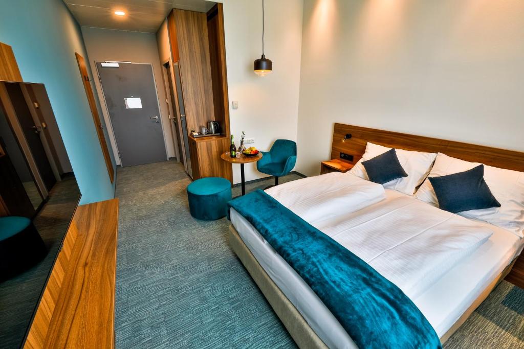 Voodi või voodid majutusasutuse Hotel Das Zeit toas