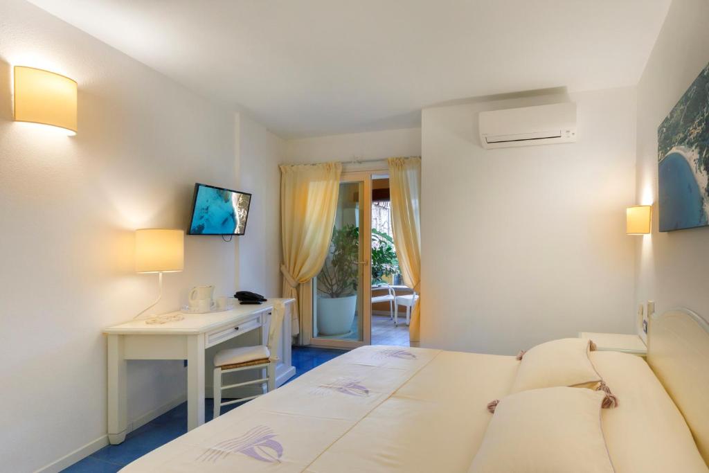 Posteľ alebo postele v izbe v ubytovaní Janas Hotel
