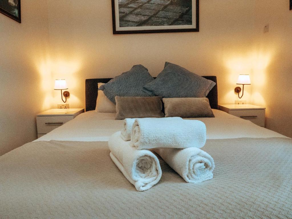 a bedroom with a bed with towels on it at The Maltese Sun in Sliema