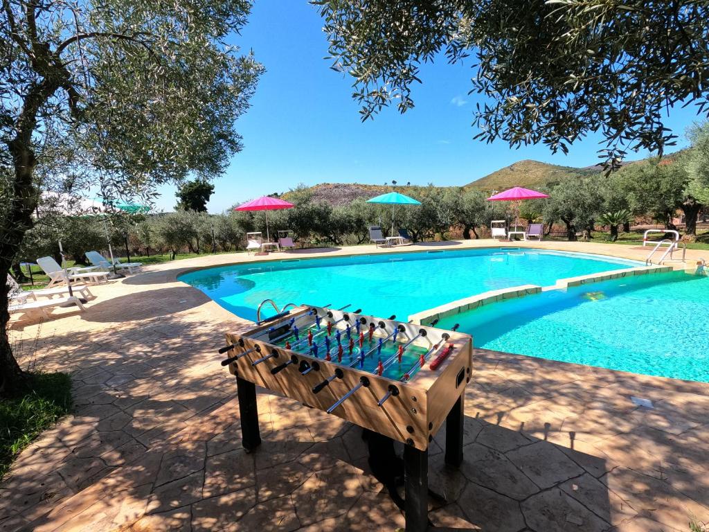 a swimming pool with a bench in front of it at Recidence Villa Olivia in Itri