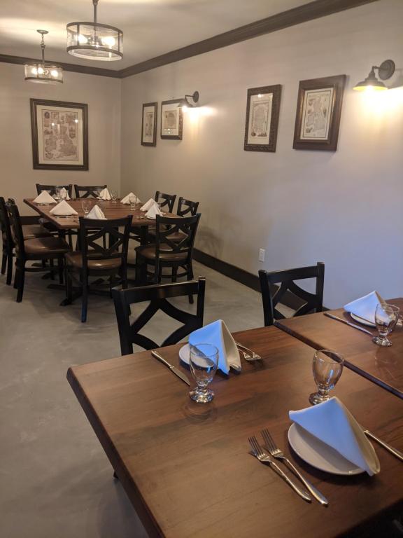 a dining room with wooden tables and chairs at Inn at the Falls in Bracebridge