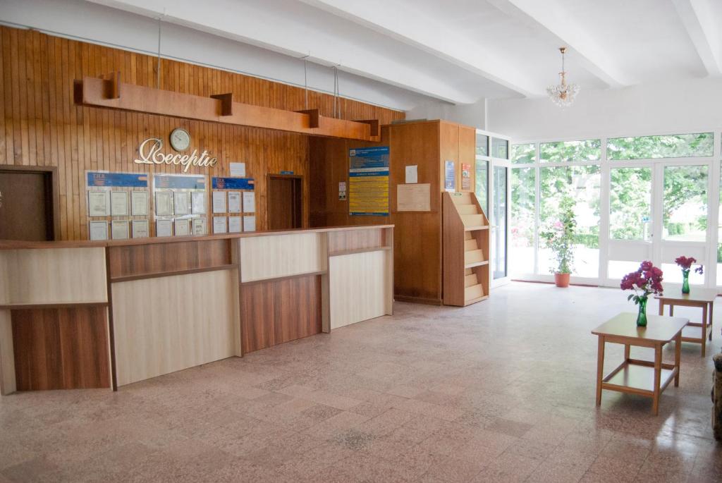 a large lobby with wooden cabinets and a table at Hotel Prahova in Saturn