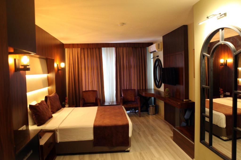 Postel nebo postele na pokoji v ubytování Aktas Hotel