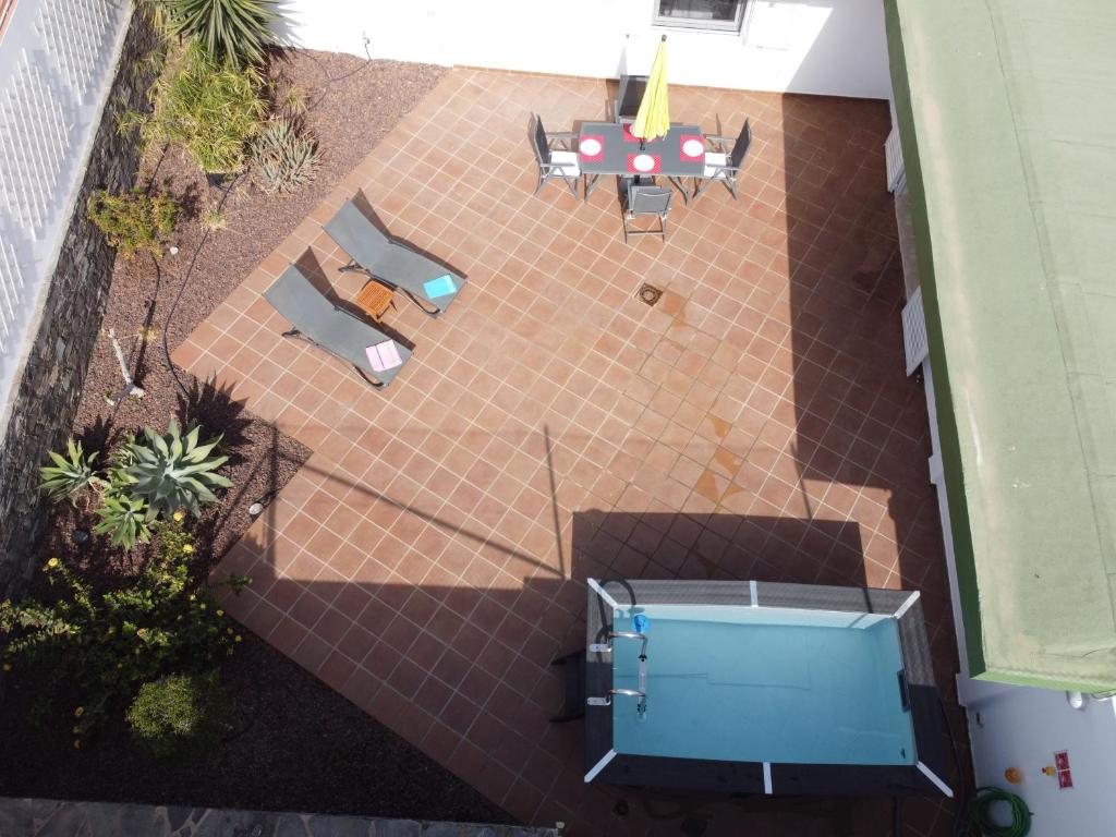 an overhead view of a patio with a table and chairs at Fantastica vivienda en Playa de San Agustin con piscina in San Agustin