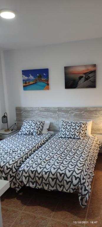 two beds sitting next to each other in a bedroom at CASA ROBERTO CANDELARIA,PARKING,AIR,WIFi in Candelaria