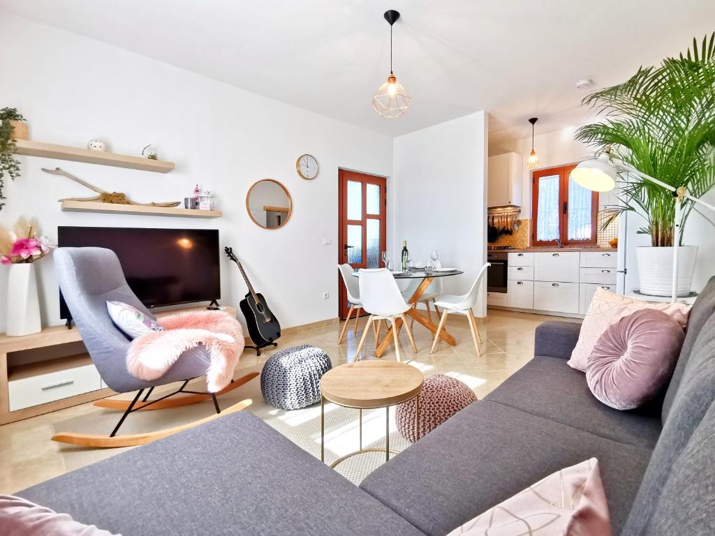 a living room with a couch and chairs and a table at Apartment Artemis in Višnjan