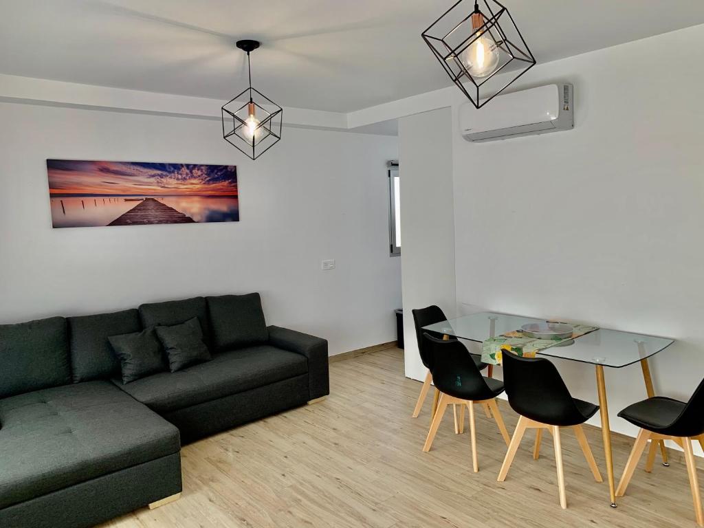 a living room with a couch and a glass table at Arguineguin Beach Lux Solarium Suit in Arguineguín