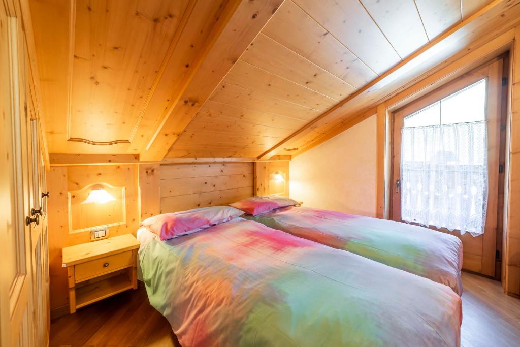 Posteľ alebo postele v izbe v ubytovaní Chalet La Nuvola