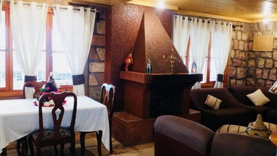 a living room with a table and a fireplace at maison d'hôtes yamine in Beni Mellal