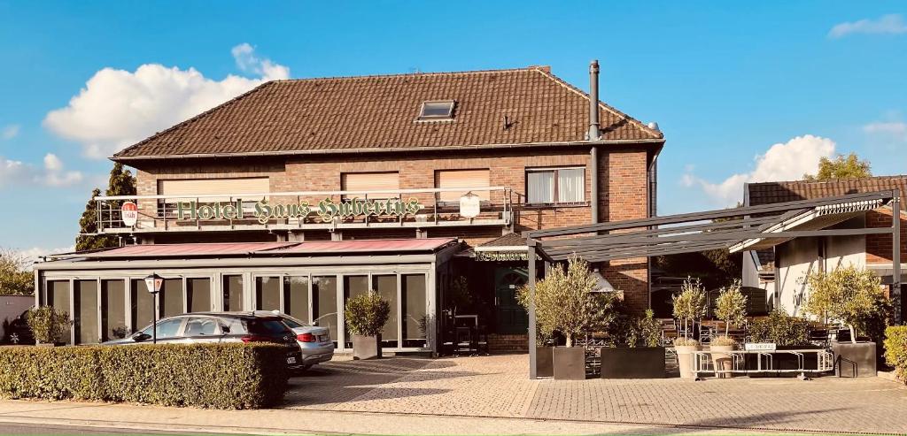 a building with a car parked in front of it at Hotel Haus Hubertus in Elsdorf