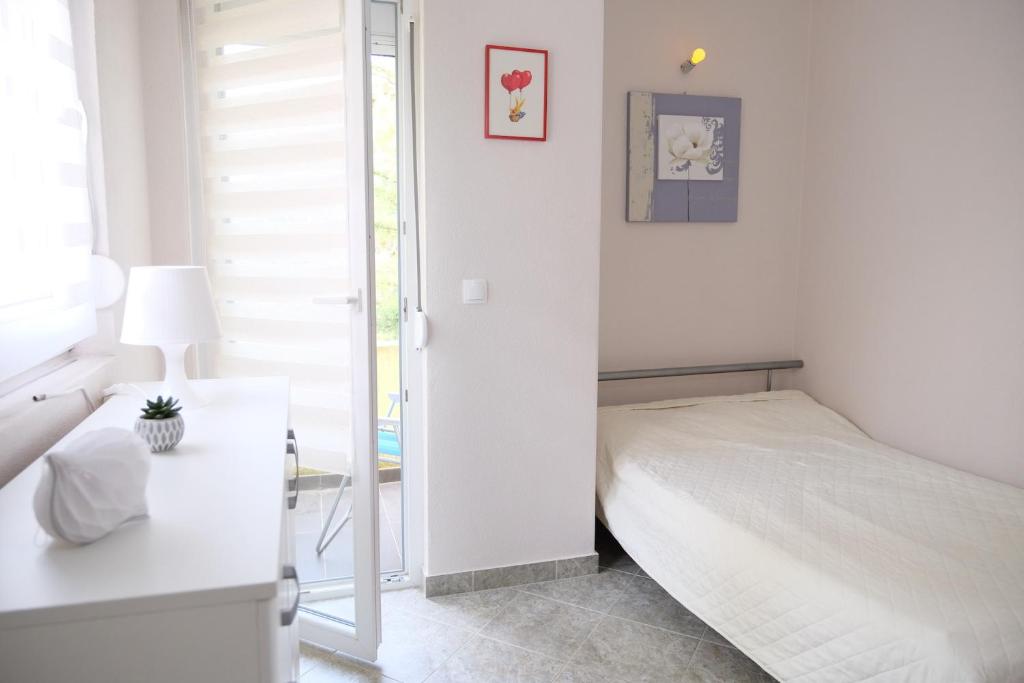 Postel nebo postele na pokoji v ubytování Apartments Jasmina