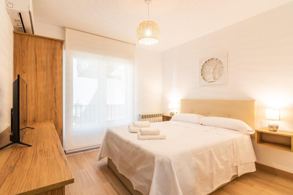 Postel nebo postele na pokoji v ubytování tuGuest San Agustin Apartment