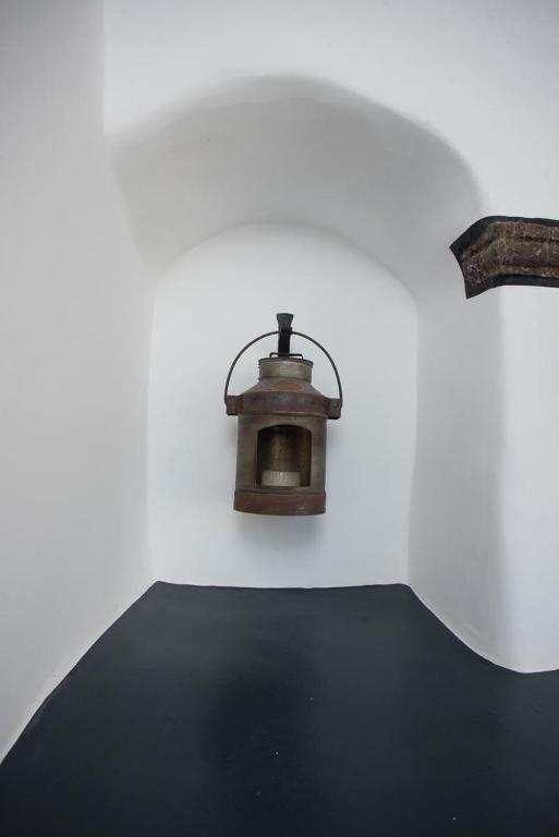 a small oven in a white walled room at Villa Orpheus Santorini in Megalokhori