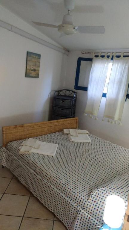 a bedroom with a bed with two towels on it at Villa Vera trifamigliare con ingresso diretto 20 mt al mare clima wi-fi bbq in Cala Liberotto
