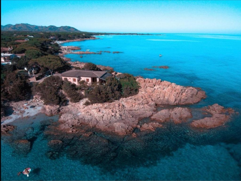 a house on a small island in the water at Villa Vera trifamigliare con ingresso diretto 20 mt al mare clima wi-fi bbq in Cala Liberotto