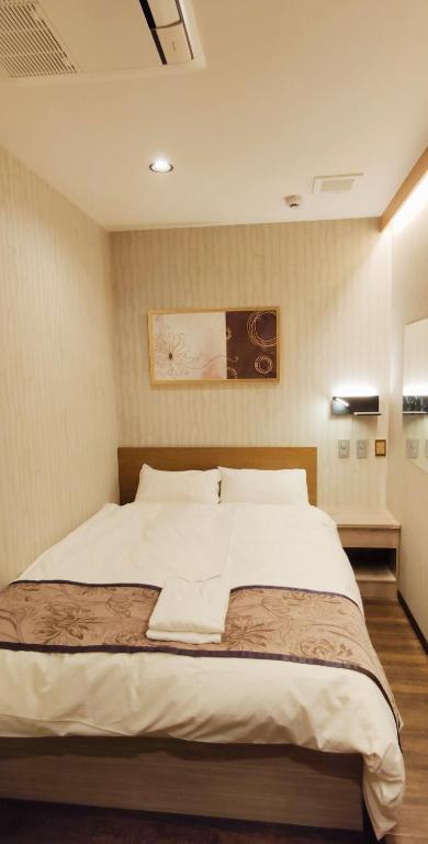 Postel nebo postele na pokoji v ubytování Hotel Charire Kichijoji