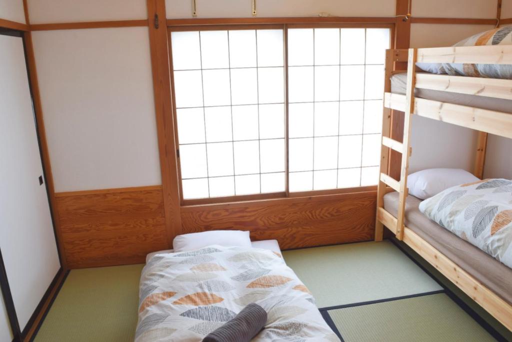 Postel nebo postele na pokoji v ubytování Myoko House