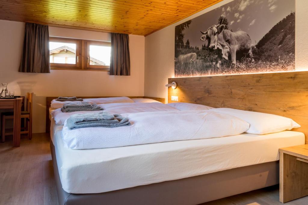 Postel nebo postele na pokoji v ubytování Hotel Walser