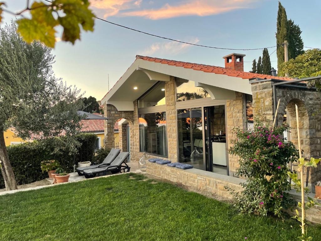 a brick house with a lawn in front of it at Studio Solare in Portorož