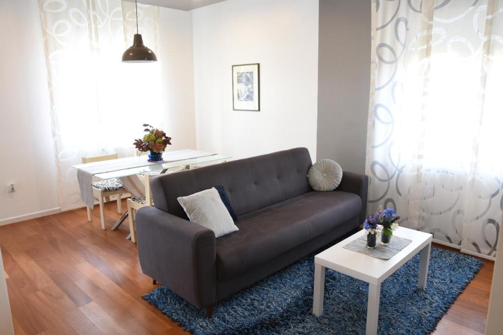ein Wohnzimmer mit einem Sofa und einem Tisch in der Unterkunft Api Apartment in Zagreb