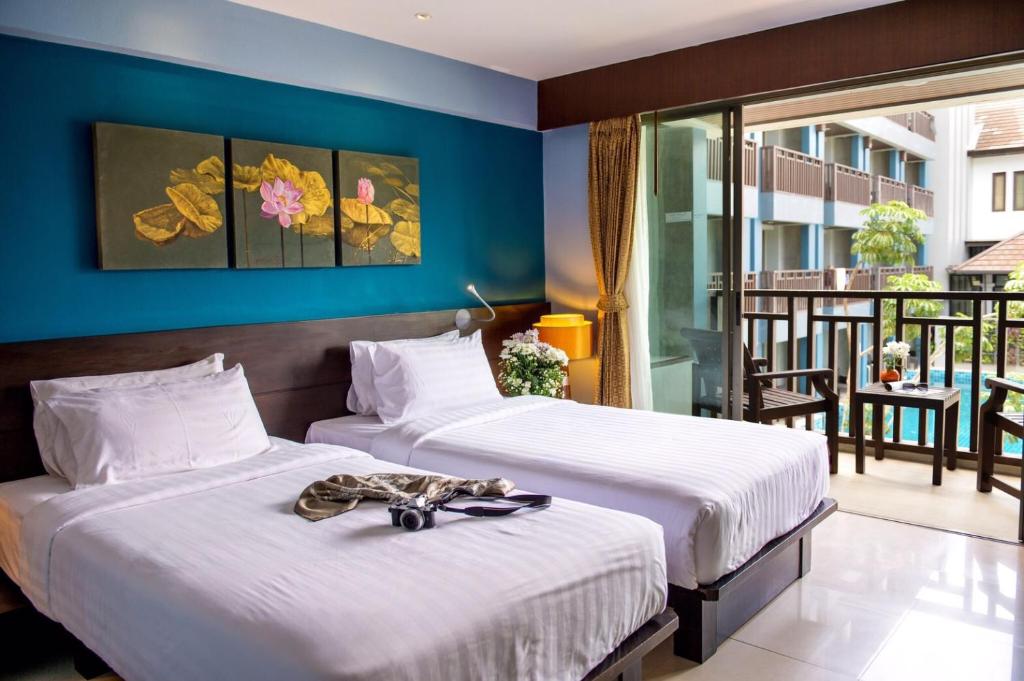 Postel nebo postele na pokoji v ubytování Blue Tara Hotel Krabi Ao Nang