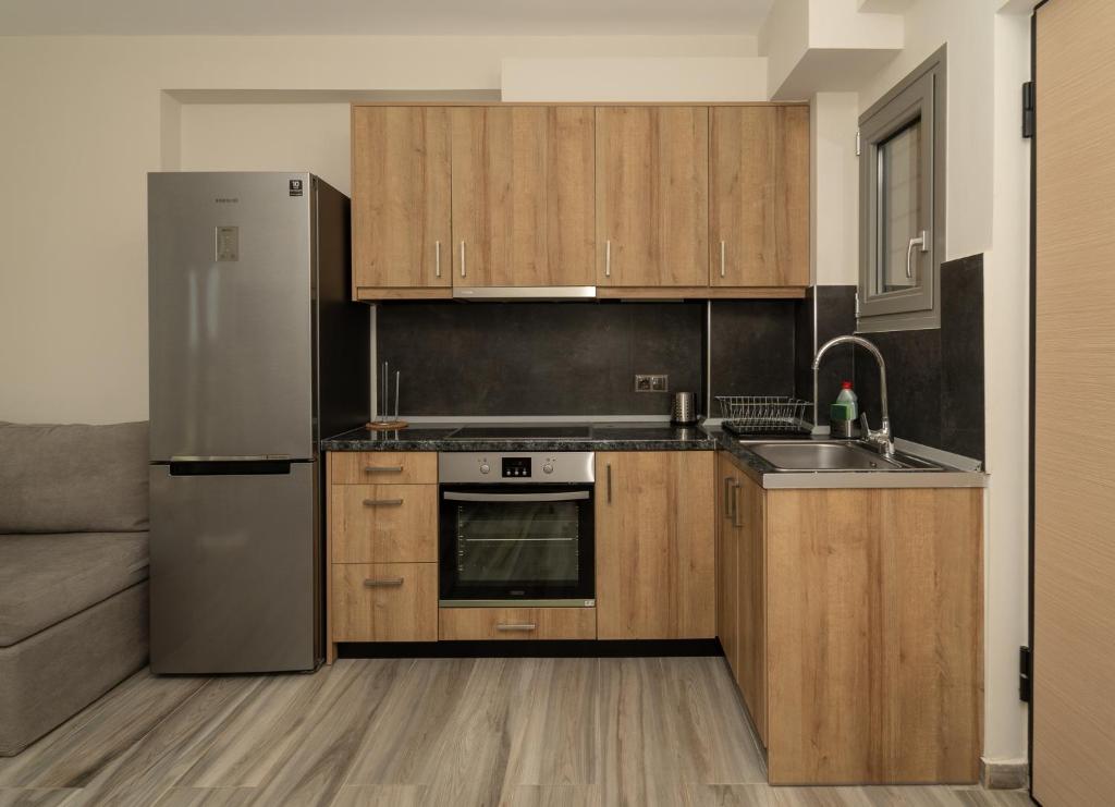 A kitchen or kitchenette at CARLOS MANSION LUXURY SUITES
