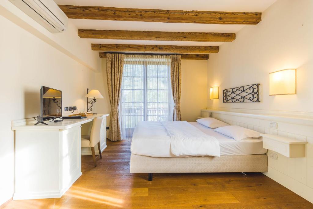 Ένα ή περισσότερα κρεβάτια σε δωμάτιο στο Hotel Relais Vecchio Maso