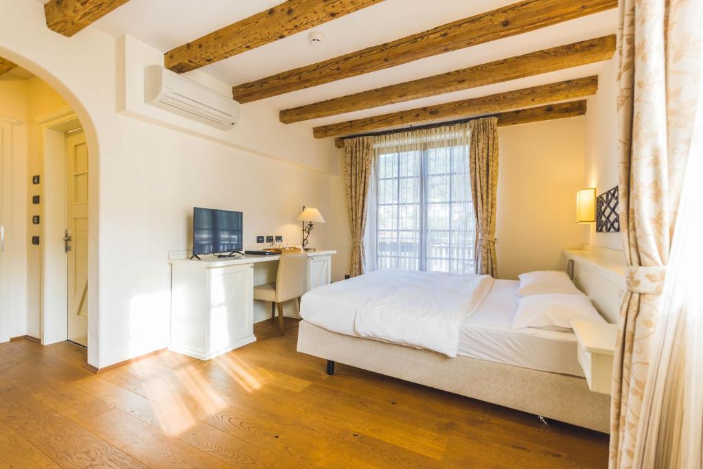Łóżko lub łóżka w pokoju w obiekcie Hotel Relais Vecchio Maso